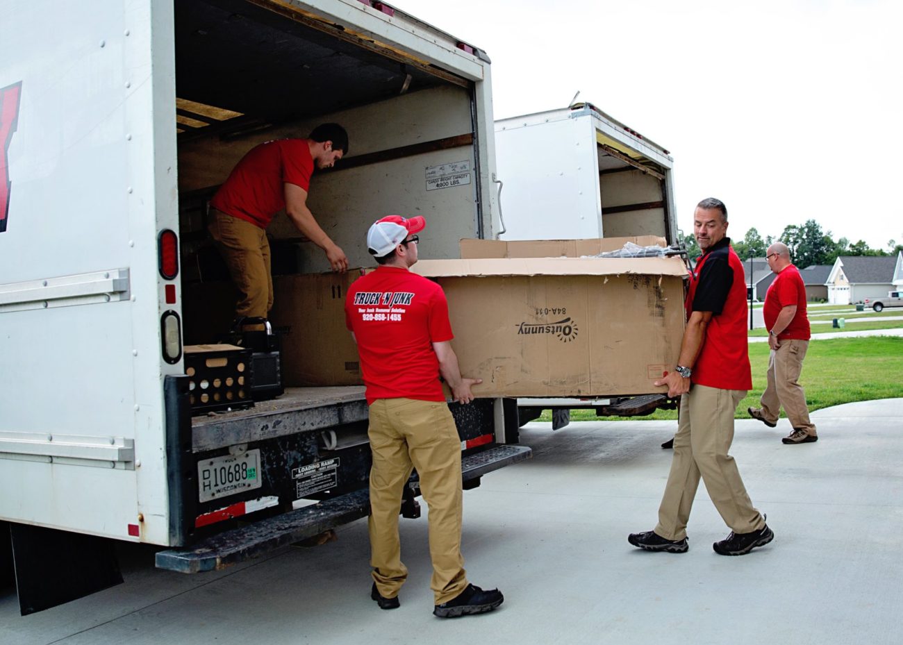 Junk removal items being loaded into the truck Junk Hauling