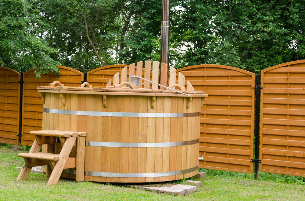 A wooden hot tub in someone's backyard
